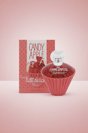 Red cupcake-shaped perfume bottle with 'Pomme d'Amour' text and matching box on a white background