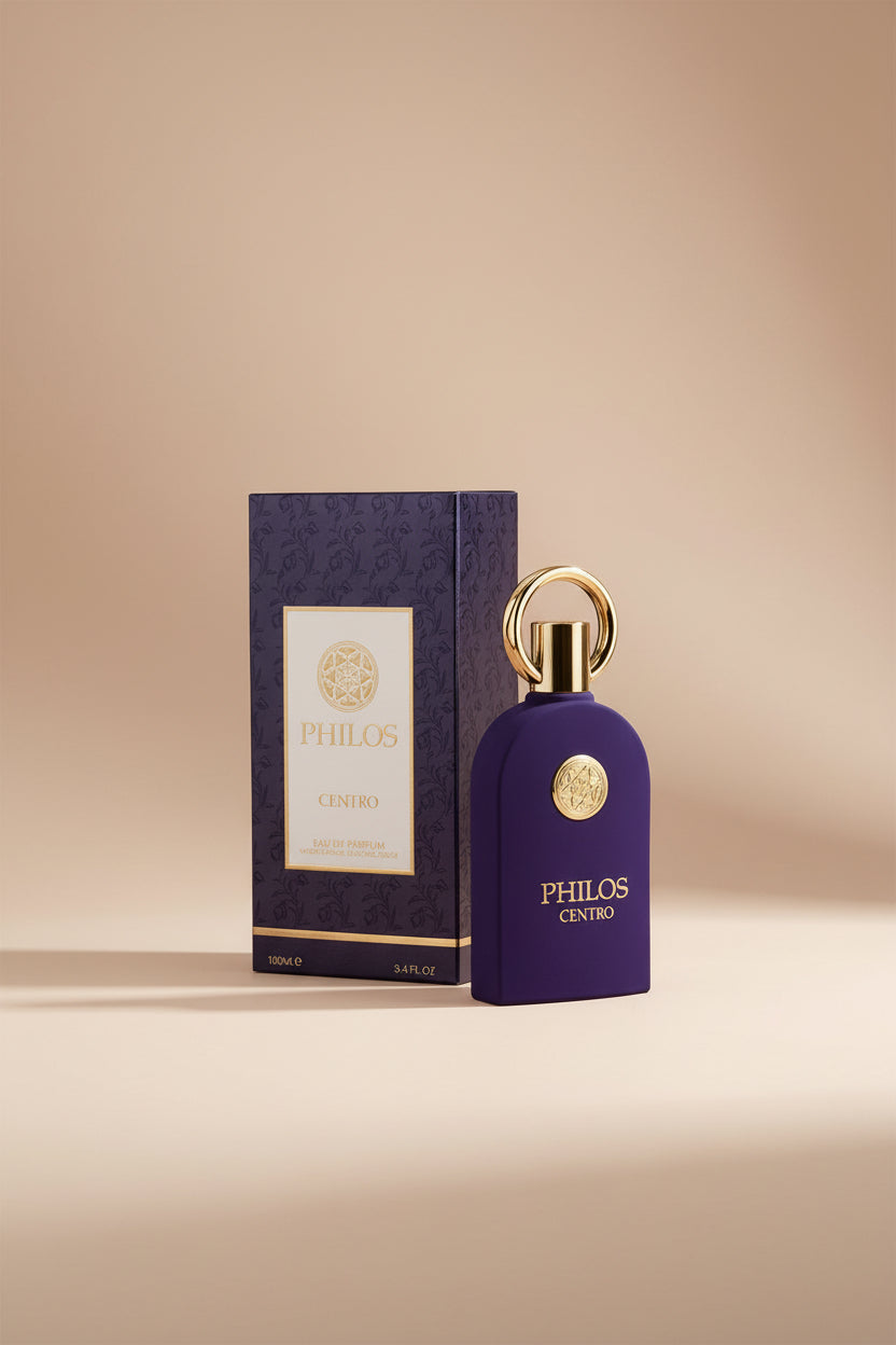 Purple perfume bottle with gold accents and 'Philos' branding next to its packaging on a white background
