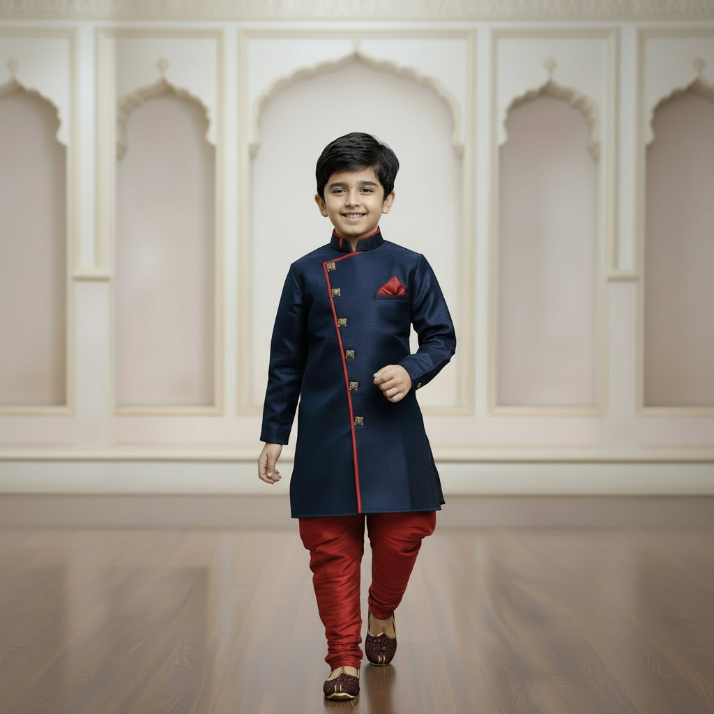 Young boy wearing a navy blue and red traditional outfit with a white background