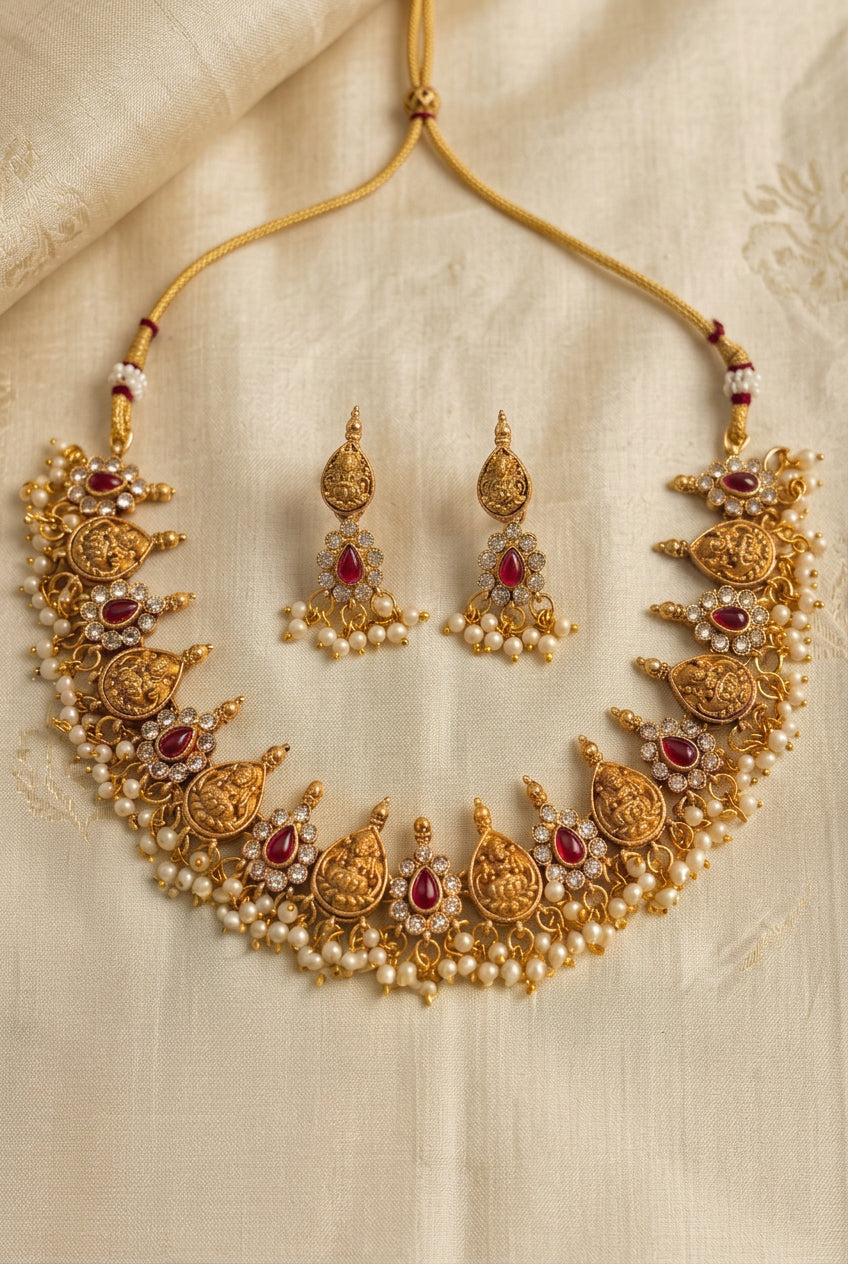 Matte Gold Finish Lakshmi Temple Choker Necklace Set with Ruby Red Stones and Pearl Beads – Imitation Jewelry
