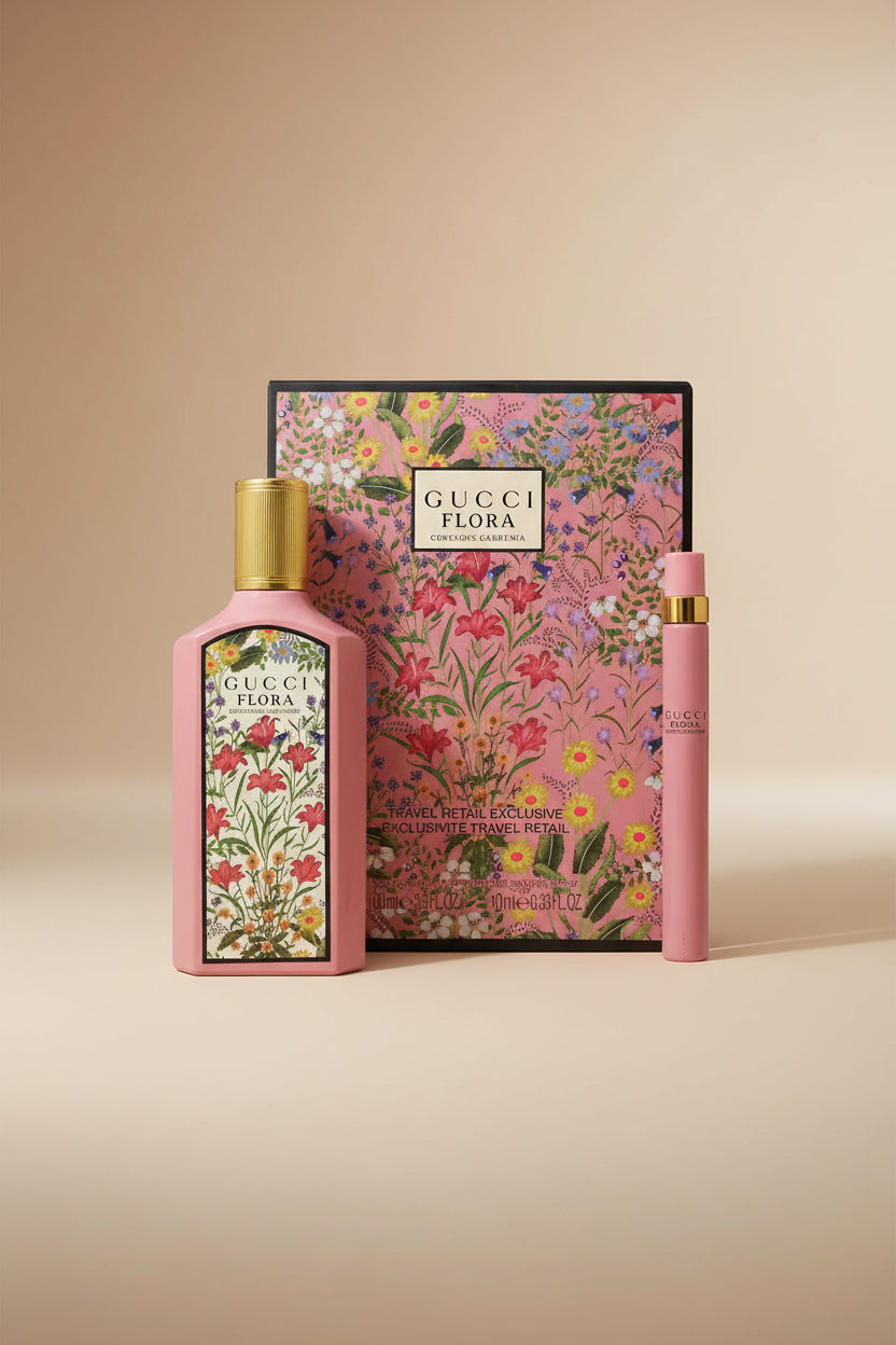 Gucci Flora perfume set with floral design on a pink background