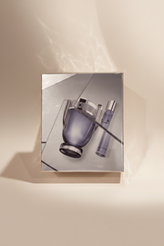 Perfume bottle and its smaller version on a reflective surface