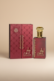 Red Ahlam Al Khaleej perfume bottle and packaging on a white background