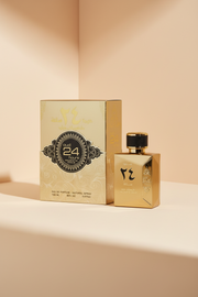 Oud 24 Hours Majestic Gold perfume bottle and packaging on a dark background